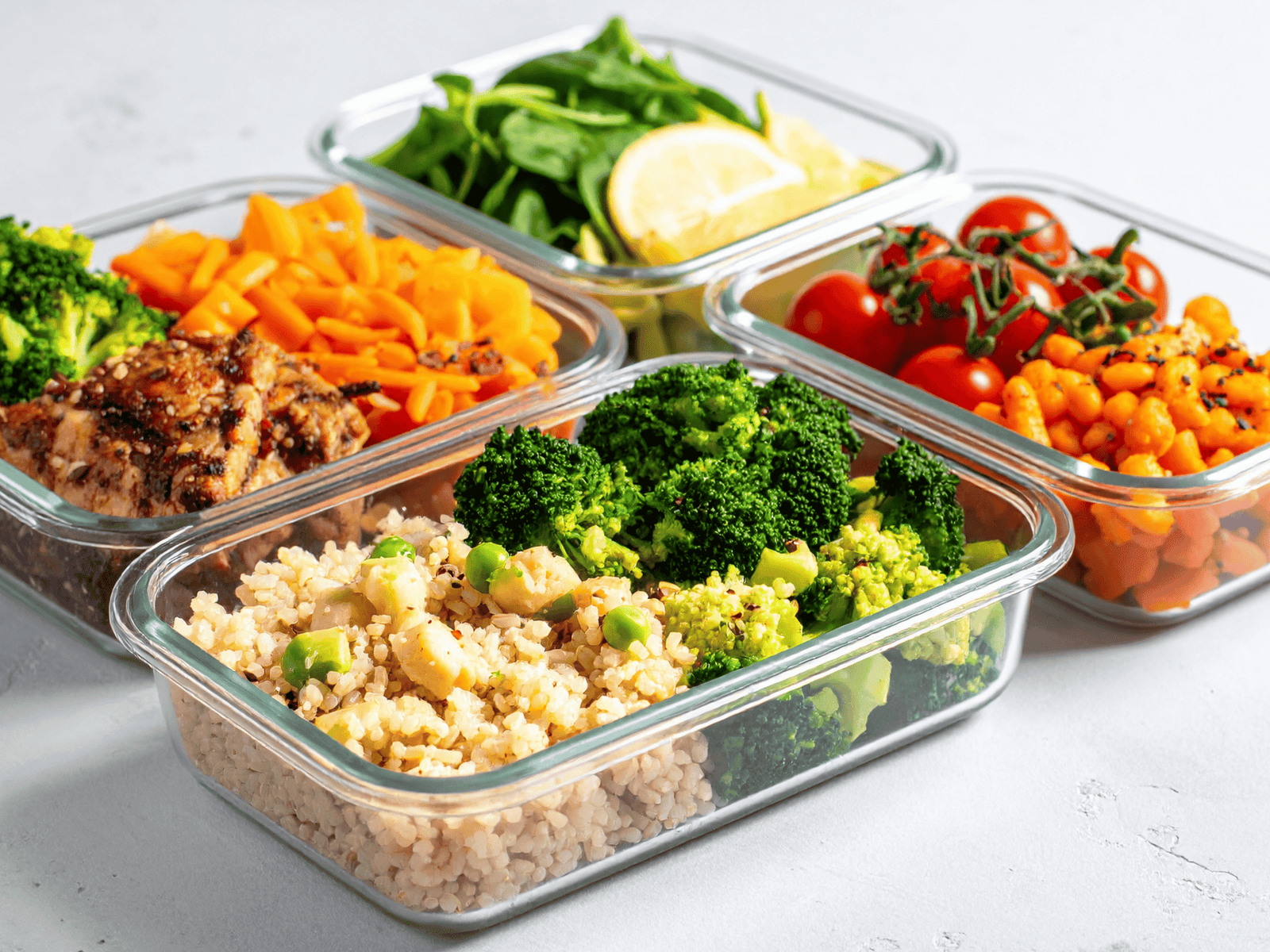 Premium glass meal prep containers with fresh proteins and vegetables